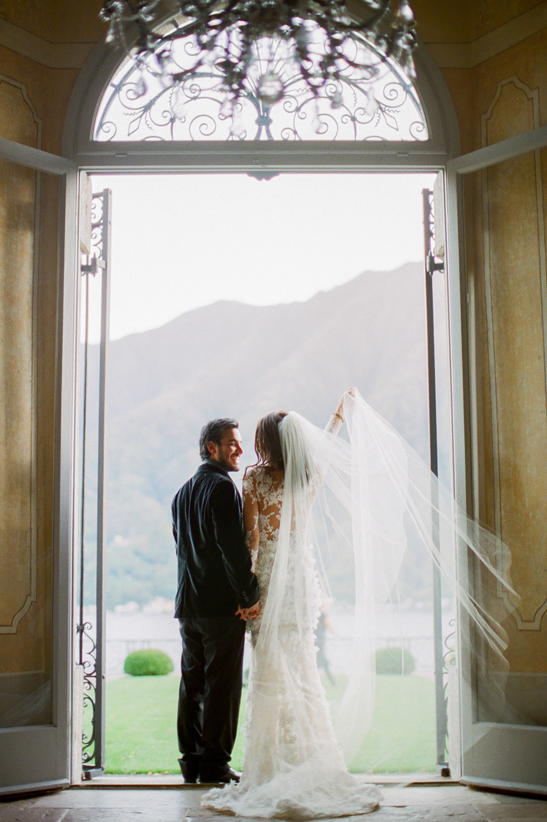 lake como bride and groom exiting villa balbiano